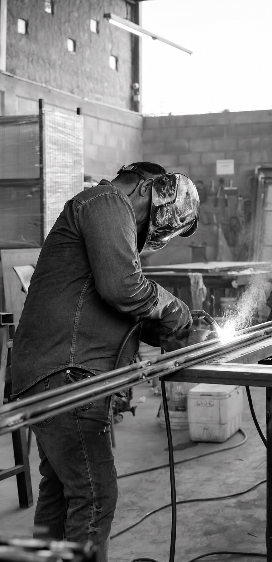Metalworker welding a steel door frame